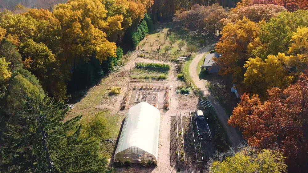An overview, shot via drone, of the gardens, including the hoop house, blueberry maze, and orchards..