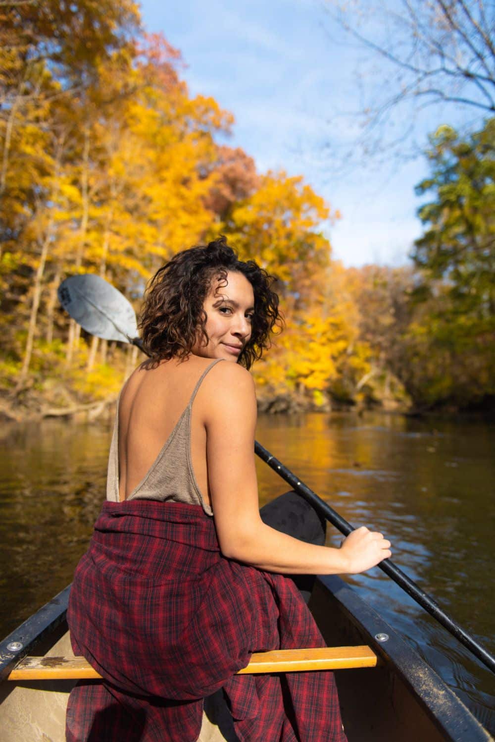 A guest enjoys a fall kayak down the Galien river.