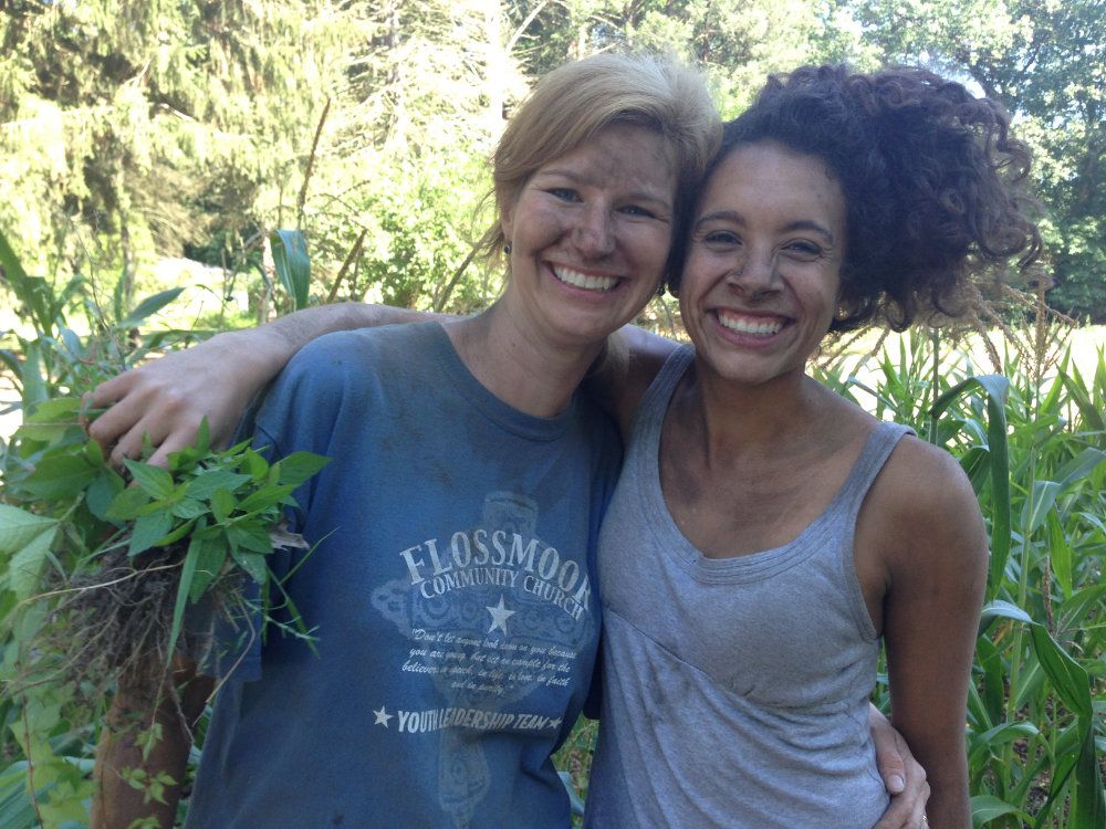 Innkeeper and intern pose for a picture covered in dirt after a long day in the field.