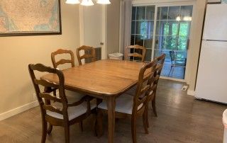 Dining area includes a table and chairs next to the kitchen.