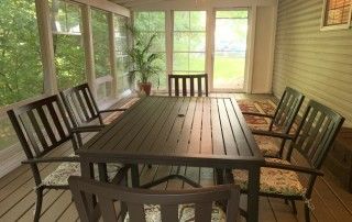 Creekside includes and inclosed back patio with table and chairs.