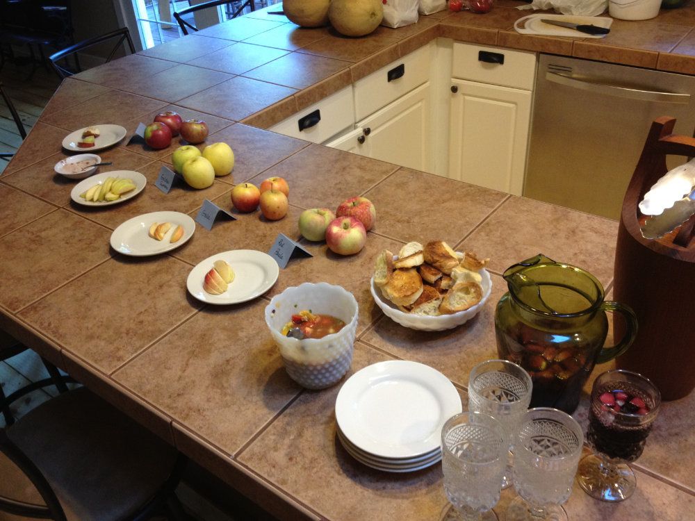 An array of homegrown apples set on plates for tasting during happy hour.
