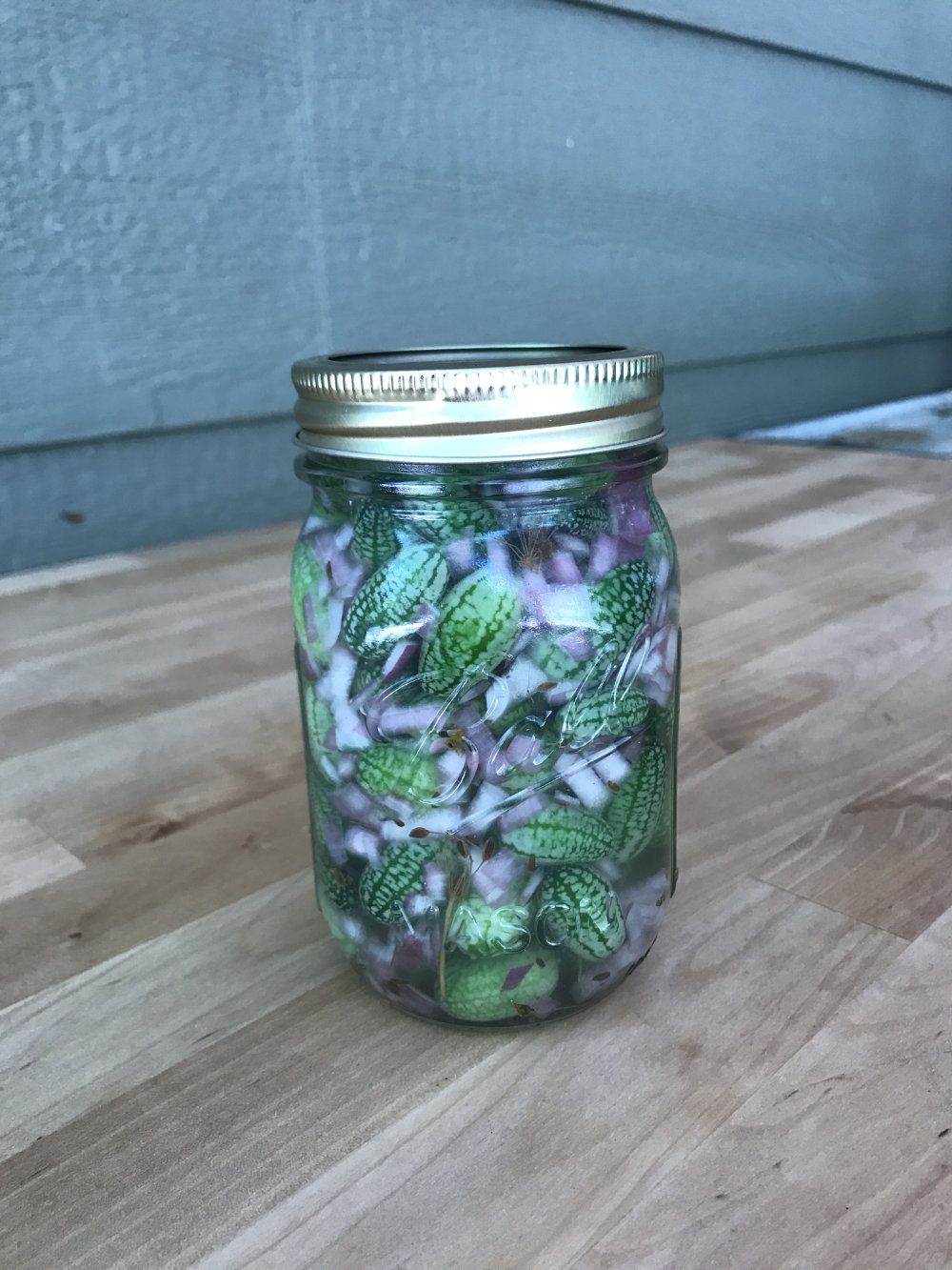 A jar of homemade pickled cucamelons.