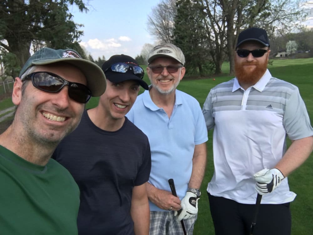 Four men enjoy local golf courses.