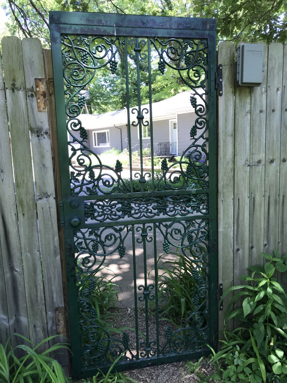 The gate in between the main property and River's Edge Cottage. The front of the cottage can be seen through the gate.