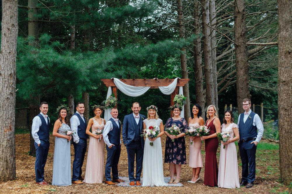 A wedding party stands in the Pine Row.