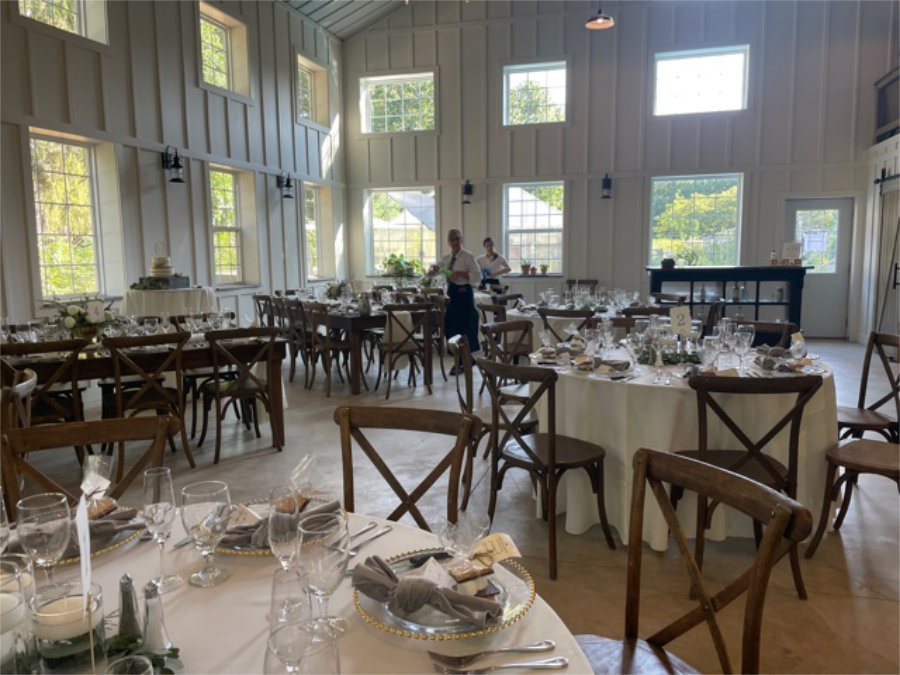 The Barn filled with decorated tables and chairs for celebration