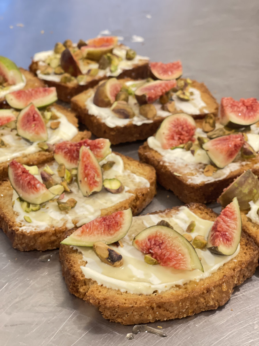 Homemade toast topped with cheese, honey from Goldberry's bees, pistachios, and home grown figs.
