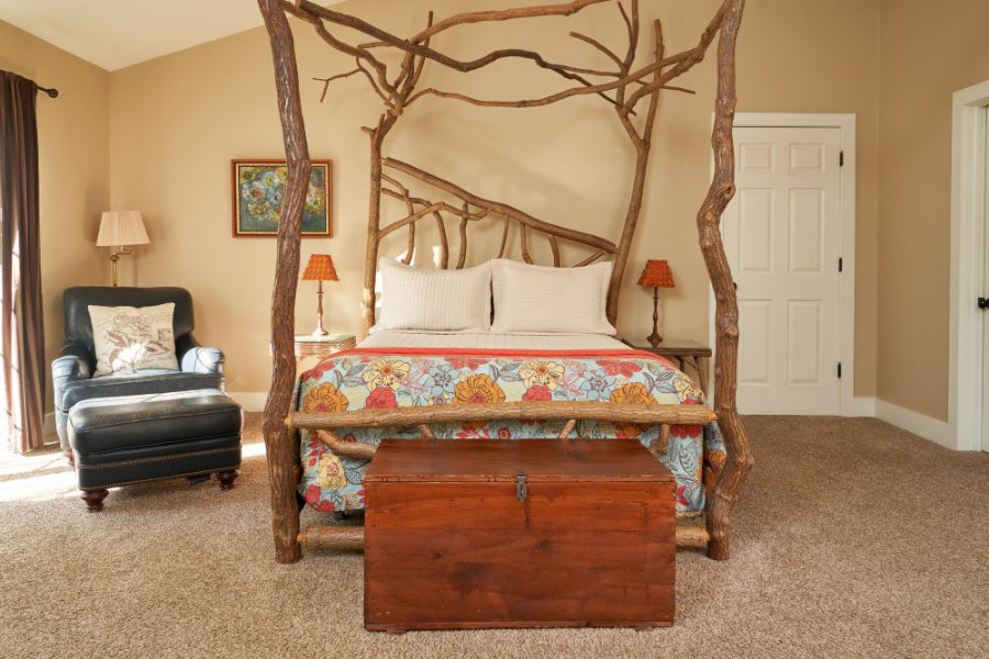 Sassafras bed paired with vintage leather chair and ottoman.