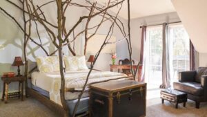 bed with natural branch frame and canopy in the american hornbeam suite at goldberry woods