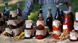 a farm stand with homemade wine preserved fruits and vegetables and jams
