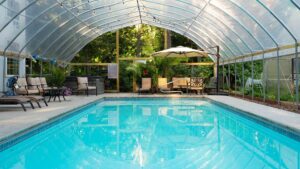 Indoor pool at Goldberry Woods with view of the surrounding wooded area.