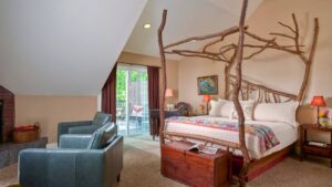 The Sassafras suite in the Inn at Goldberry Woods in Union Pier, MI. The king bed has a canopy of natural tree limbs custom-built by local artisans.