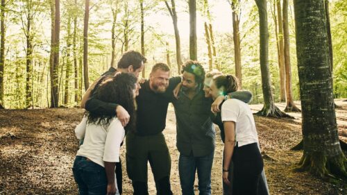 team huddle in the woods during a corporate retreat