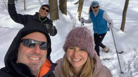 eric and julie with another couple snowshoeing in the woods