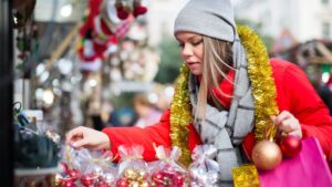 woman looking at christmas decor at a holiday street market