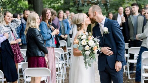 couple kissing in the aisle at the end of their goldberry woods ceremony