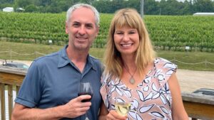 goldberry woods innkeepers julie and eric smiling and drinking wine at dablon winery