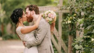bride and groom kissing and hugging posing in the gardens at goldberry woods