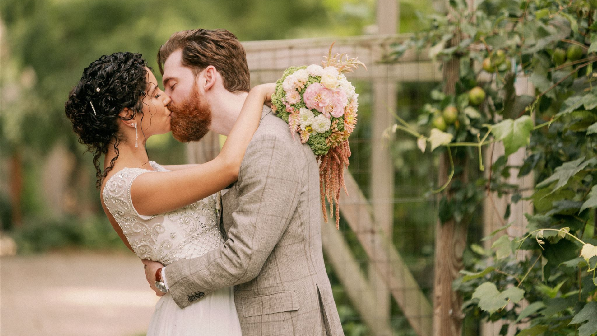 Image of bride and groom kissing at elopement at Goldberry Woods modern farm resort in Harbour County Michigan