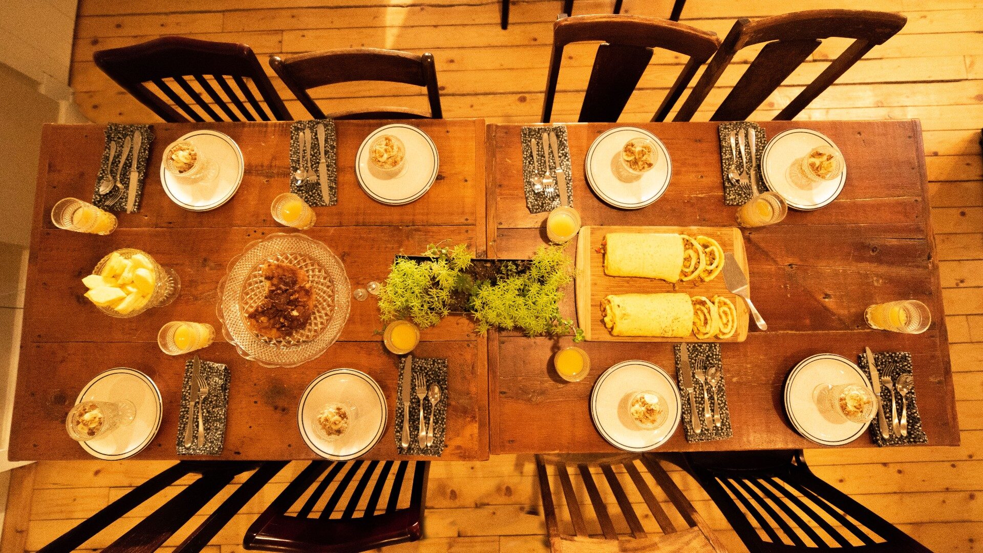 Overhead view of a table for eight set up for breakfast