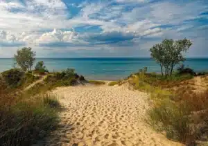 Shot of a sandy path lined with beach grass leading down to lake Michigan