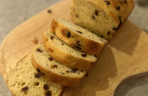 Irish Soda Bread with raisins and caraway seeds sliced on a cutting board